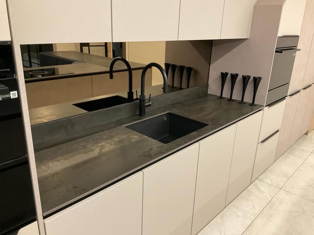 Grey mirror splashback installed in a modern kitchen
