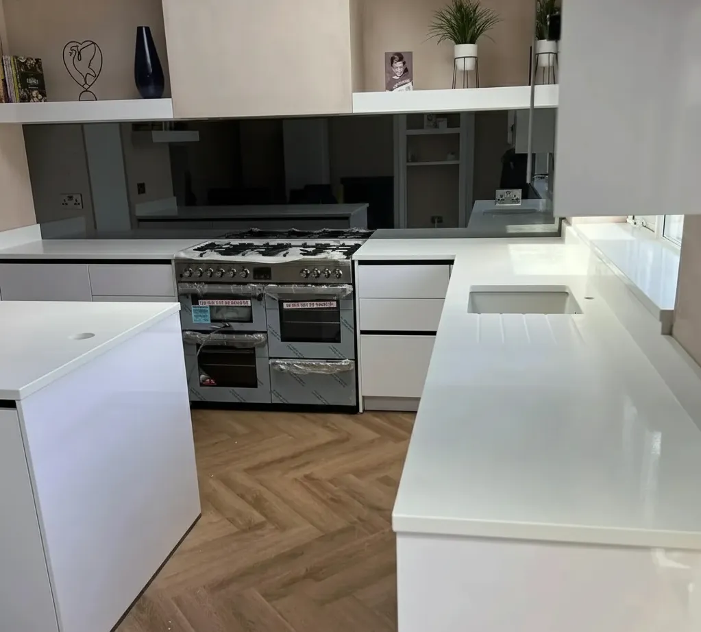 Grey mirror splashback in contemporary white kitchen