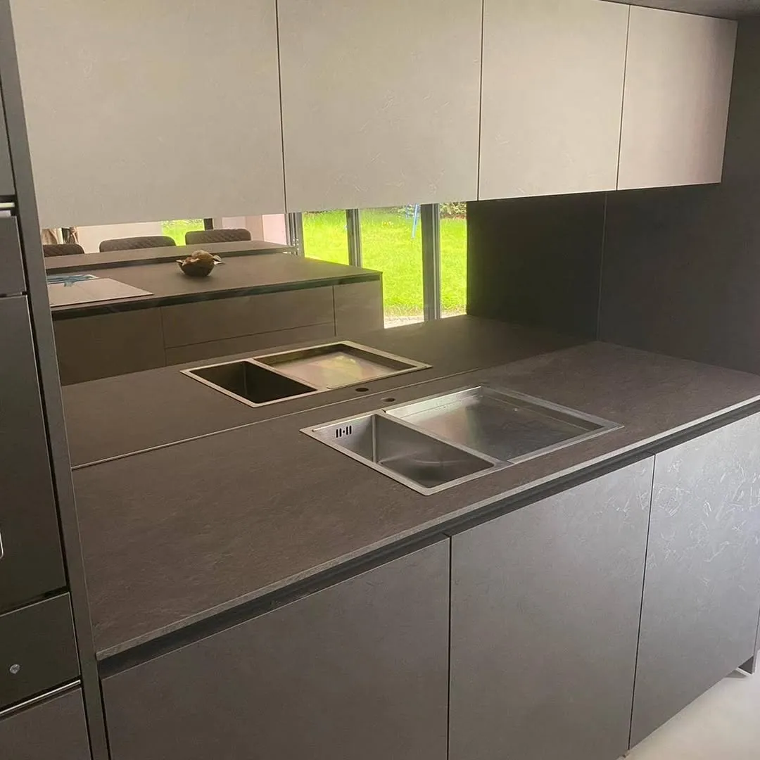 Grey mirror splashback with island kitchen