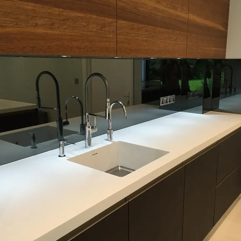 Grey mirror splashback with island kitchen
